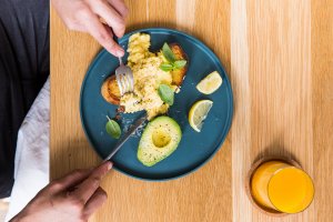 Scrambled eggs with toast and avocado