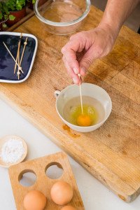Piercing the yolk with a skewer