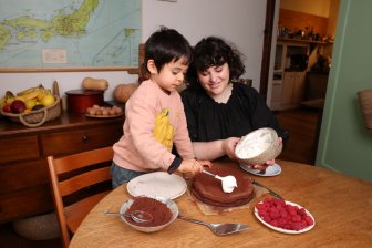 Julia and her son Haruki decorating a chocolate cake