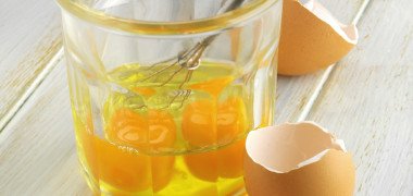 Cracked eggs in glass