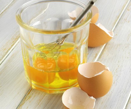 Cracked eggs in glass