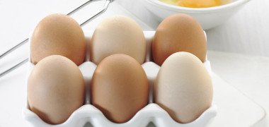 Six eggs with cracked egg behind