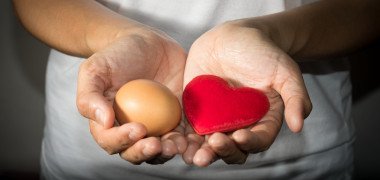 woman holding egg and heart
