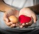 woman holding egg and heart